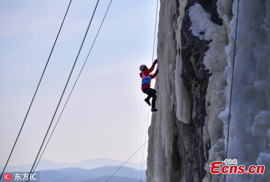 A participant ascends a frozen fall during a competition in Vladivostok, Russia, Feb. 9, 2019. (Photo/IC)