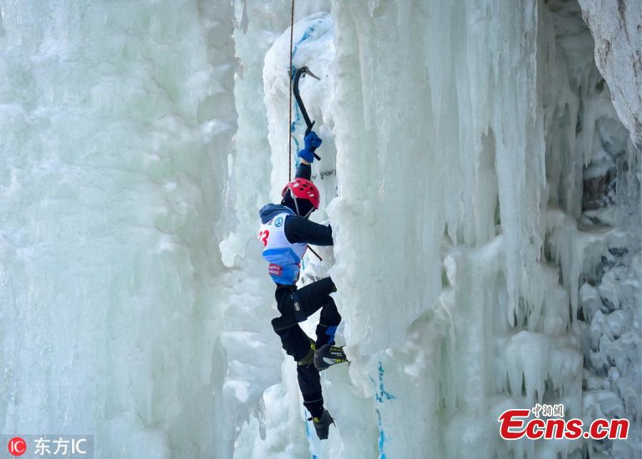 A participant ascends a frozen fall during a competition in Vladivostok, Russia, Feb. 9, 2019. (Photo/IC)