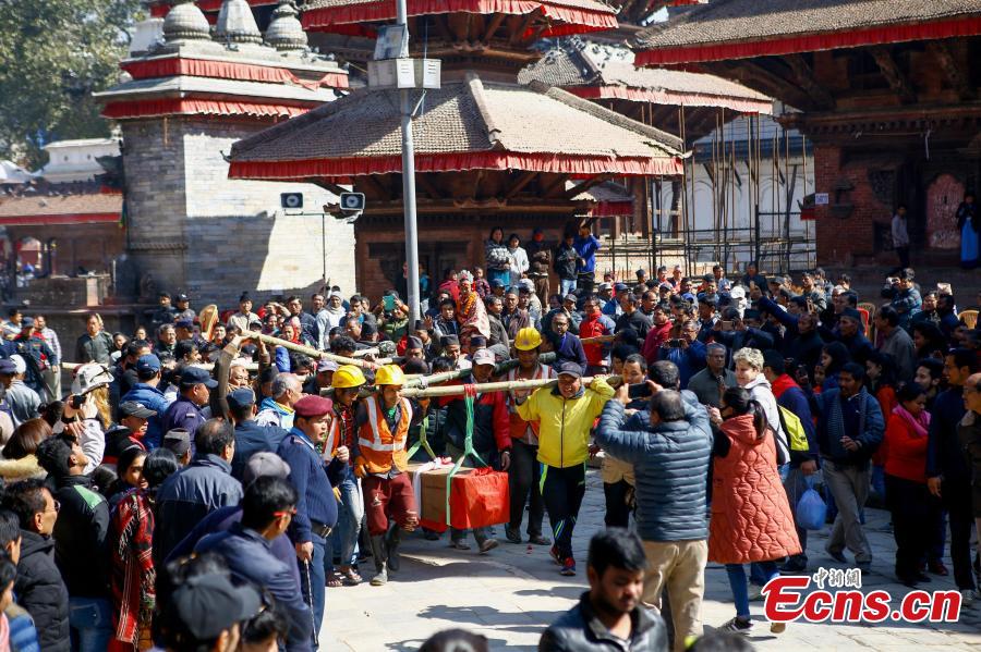 People carry wooden pillars for erection at the reconstruction site of the Kasthamandap temple at Hanumandhoka Durbar Square in Kathmandu, Nepal, Feb. 10, 2019. A ceremony was held to keep the wooden pillars to reconstruct the Kasthamandap temple, which was destroyed during the 2015 earthquake. Kasthamandap (Kastha: wood, mandap: pavilion) temple is one of the oldest and historical building in Kathmandu. (Photo: China News Service/Pu Ladan)