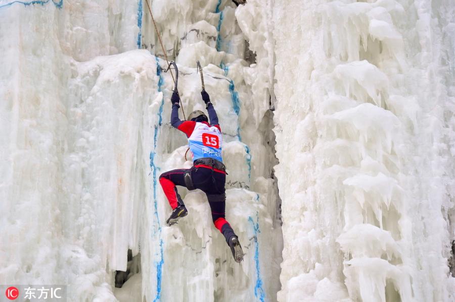 A participant ascends a frozen fall during a competition in Vladivostok, Russia, Feb. 9, 2019. (Photo/IC)