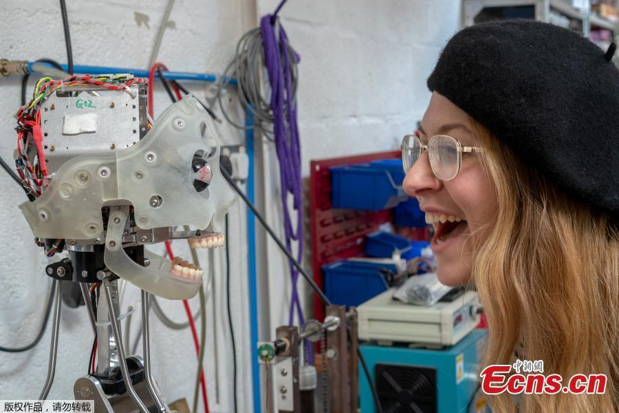 A woman interacts with Ai-da, a humanoid robot capable of drawing people from life using her bionic eyes and hand, at the offices of robotics company Engineered Arts, in Falmouth, Cornwall, Britain, Feb. 7, 2019. (Photo/Agencies)