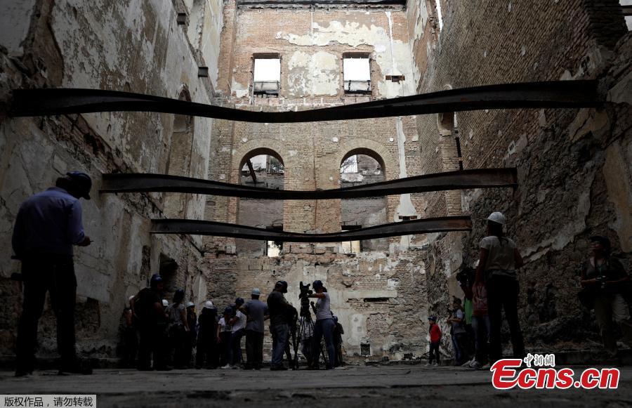 Media members visit the Brazil National Museum after its devastating fire, in Rio de Janeiro, Brazil, Feb. 12, 2019. Five months after fire gutted Brazil\'s 200-year-old National Museum, the site that once held some of the nation\'s greatest treasures remains a ruin of scorched walls, twisted metal and piles of ash. (Photo/Agencies)