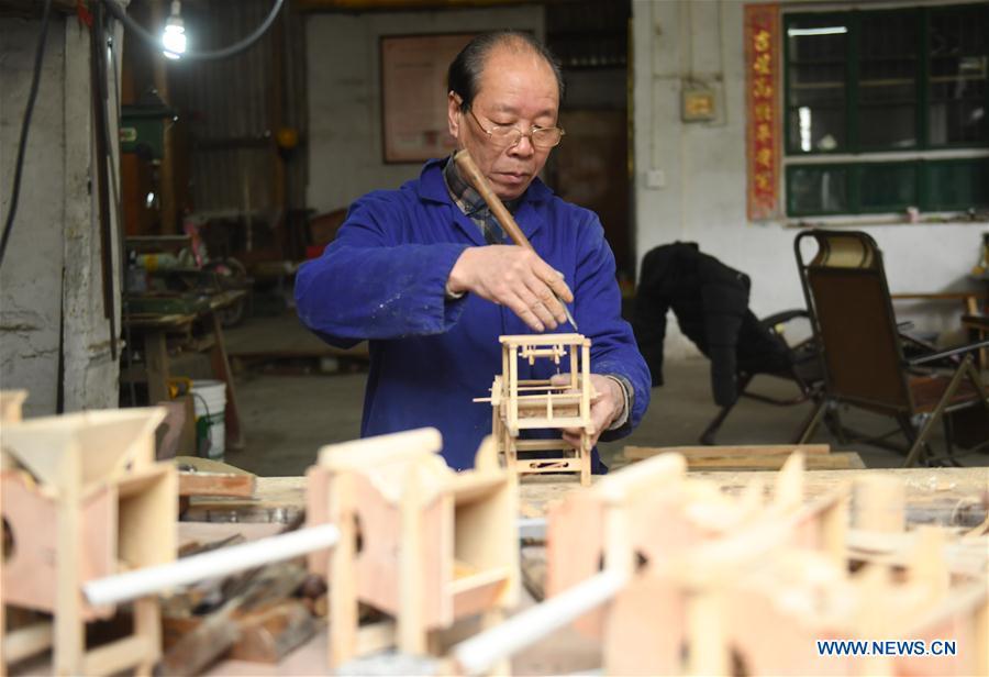 Lin Shunkui shows his tools for making ornamental dragon at home in Beibaixiang Town of Yueqing, east China\'s Zhejiang Province, Feb. 11, 2019. Having a history of more than 400 years, the ornamental dragon, a sacrifice to pray for good fortune during the period of Lantern Festival, is popular in villages of Yueqing City in Zhejiang Province. Lin Shunkui, an inheritor of the handicraft of ornamental dragon, is born in 1956 in Dongchan Village of Beibaixiang Town. Learning the art since he was young from his father, who is a master of fine paper-cutting, Lin has been in the walk for more than 40 years and has been famous for his exquisite handicraft. The making procedures of the ornamental dragon require high standards and needs preparation of more than half a year. The craftsman must be proficient in various vocations such as paper-cutting, carpentry, painting and machinery. Usually having a height of four meters, a length of three meters and a width of two meters, the ornamental dragon displays about 300 figures in more than 80 cabinets, which are driven by gears hidden inside the dragon body. The handicraft of ornamental dragon was listed as one of the national intangible cultural heritages in October of 2014. (Xinhua/Weng Xinyang)