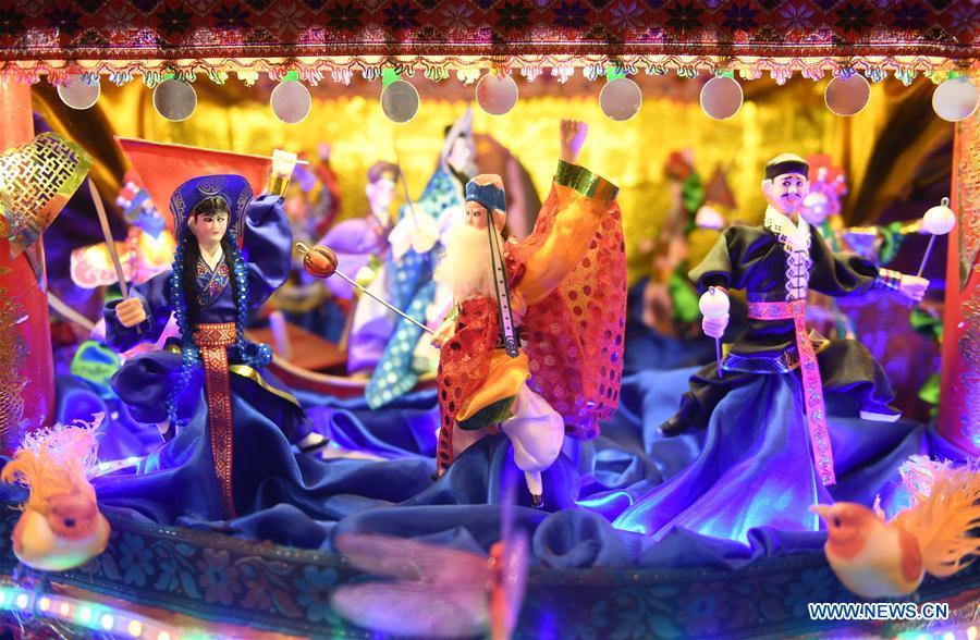 Photo taken on Feb. 11, 2019 shows figures on ornamental dragon in Beibaixiang Town of Yueqing, east China\'s Zhejiang Province. Having a history of more than 400 years, the ornamental dragon, a sacrifice to pray for good fortune during the period of Lantern Festival, is popular in villages of Yueqing City in Zhejiang Province. Lin Shunkui, an inheritor of the handicraft of ornamental dragon, is born in 1956 in Dongchan Village of Beibaixiang Town. Learning the art since he was young from his father, who is a master of fine paper-cutting, Lin has been in the walk for more than 40 years and has been famous for his exquisite handicraft. The making procedures of the ornamental dragon require high standards and needs preparation of more than half a year. The craftsman must be proficient in various vocations such as paper-cutting, carpentry, painting and machinery. Usually having a height of four meters, a length of three meters and a width of two meters, the ornamental dragon displays about 300 figures in more than 80 cabinets, which are driven by gears hidden inside the dragon body. The handicraft of ornamental dragon was listed as one of the national intangible cultural heritages in October of 2014. (Xinhua/Weng Xinyang)