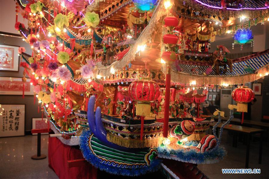 Photo shows the ornamental dragon at Lin Shunkui\'s home in Beibaixiang Town of Yueqing, east China\'s Zhejiang Province, Feb. 11, 2019. Having a history of more than 400 years, the ornamental dragon, a sacrifice to pray for good fortune during the period of Lantern Festival, is popular in villages of Yueqing City in Zhejiang Province. Lin Shunkui, an inheritor of the handicraft of ornamental dragon, is born in 1956 in Dongchan Village of Beibaixiang Town. Learning the art since he was young from his father, who is a master of fine paper-cutting, Lin has been in the walk for more than 40 years and has been famous for his exquisite handicraft. The making procedures of the ornamental dragon require high standards and needs preparation of more than half a year. The craftsman must be proficient in various vocations such as paper-cutting, carpentry, painting and machinery. Usually having a height of four meters, a length of three meters and a width of two meters, the ornamental dragon displays about 300 figures in more than 80 cabinets, which are driven by gears hidden inside the dragon body. The handicraft of ornamental dragon was listed as one of the national intangible cultural heritages in October of 2014. (Xinhua/Zhu Weixi)