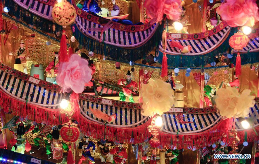Photo taken on Feb. 11, 2019 shows figures on ornamental dragon in Beibaixiang Town of Yueqing, east China\'s Zhejiang Province. Having a history of more than 400 years, the ornamental dragon, a sacrifice to pray for good fortune during the period of Lantern Festival, is popular in villages of Yueqing City in Zhejiang Province. Lin Shunkui, an inheritor of the handicraft of ornamental dragon, is born in 1956 in Dongchan Village of Beibaixiang Town. Learning the art since he was young from his father, who is a master of fine paper-cutting, Lin has been in the walk for more than 40 years and has been famous for his exquisite handicraft. The making procedures of the ornamental dragon require high standards and needs preparation of more than half a year. The craftsman must be proficient in various vocations such as paper-cutting, carpentry, painting and machinery. Usually having a height of four meters, a length of three meters and a width of two meters, the ornamental dragon displays about 300 figures in more than 80 cabinets, which are driven by gears hidden inside the dragon body. The handicraft of ornamental dragon was listed as one of the national intangible cultural heritages in October of 2014. (Xinhua/Zhu Weixi)