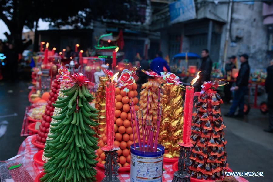 Photo taken on Feb. 11, 2019 shows sacrifices during the ornamental dragon parade in Gaoao of Beibaixiang Town of Yueqing, east China\'s Zhejiang Province. Having a history of more than 400 years, the ornamental dragon, a sacrifice to pray for good fortune during the period of Lantern Festival, is popular in villages of Yueqing City in Zhejiang Province. Lin Shunkui, an inheritor of the handicraft of ornamental dragon, is born in 1956 in Dongchan Village of Beibaixiang Town. Learning the art since he was young from his father, who is a master of fine paper-cutting, Lin has been in the walk for more than 40 years and has been famous for his exquisite handicraft. The making procedures of the ornamental dragon require high standards and needs preparation of more than half a year. The craftsman must be proficient in various vocations such as paper-cutting, carpentry, painting and machinery. Usually having a height of four meters, a length of three meters and a width of two meters, the ornamental dragon displays about 300 figures in more than 80 cabinets, which are driven by gears hidden inside the dragon body. The handicraft of ornamental dragon was listed as one of the national intangible cultural heritages in October of 2014. (Xinhua/Zhu Weixi)