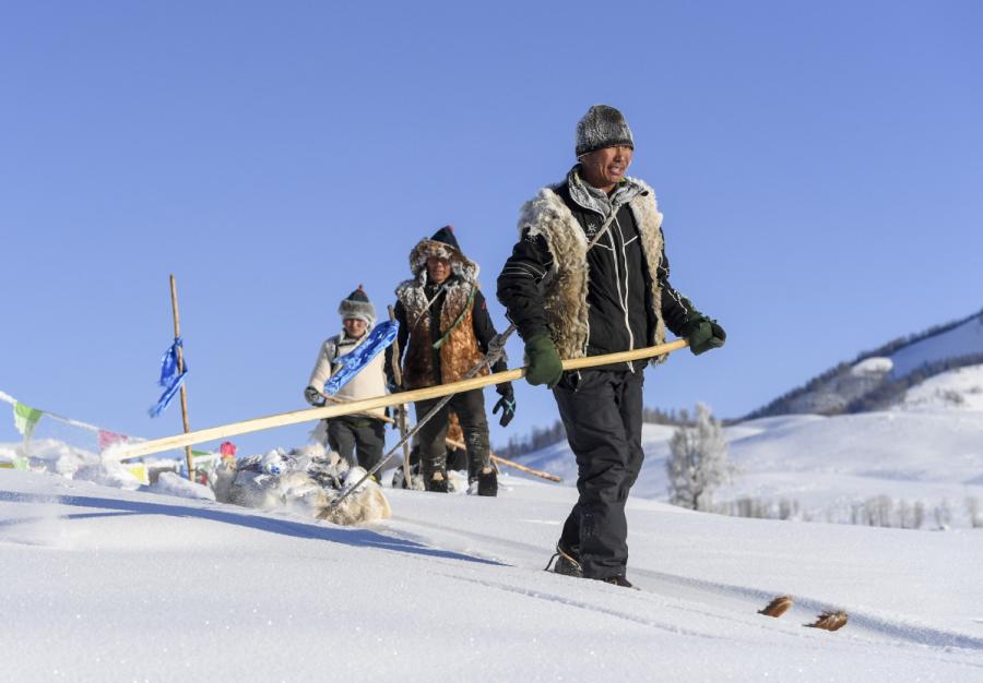 Villagers from Hemu take part in a traditional skiing activity. (Photo/Xinhua)