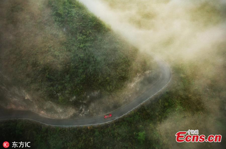An aerial photo shows bends on a road in the Qibainong National Geological Park, located in Dahua Yao Autonomous County in South China\'s Guangxi Zhuang Autonomous Region, Feb. 20, 2019. The park features a unique karst landscape with mountain ranges, low-lying lands, valleys, caves, underground rivers, and an abundance of fossils. (Photo/IC)