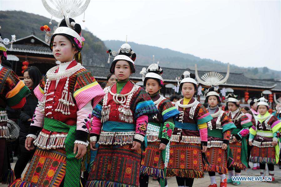 Villagers in traditional costumes perform the lusheng dance in Zhouxi Town, Kaili City of southwest China\'s Guizhou Province, Feb. 24, 2019. The ethnic Miao girls donning traditional embroidered attire and silver ornaments sing and dance to the sound of the lusheng, a reed-pipe wind instrument, to pray for a good harvest. Ethnic Miao people get together at Gannangxiang to rejoice in the annual Gannangxiang celebration, one of the largest-scale and most primitive Miao lusheng celebrations in Guizhou Province. (Xinhua/Yang Wenbin)