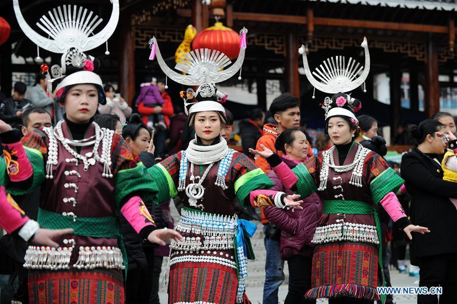 Villagers in traditional costumes perform the lusheng dance in Zhouxi Town, Kaili City of southwest China\'s Guizhou Province, Feb. 24, 2019. The ethnic Miao girls donning traditional embroidered attire and silver ornaments sing and dance to the sound of the lusheng, a reed-pipe wind instrument, to pray for a good harvest. Ethnic Miao people get together at Gannangxiang to rejoice in the annual Gannangxiang celebration, one of the largest-scale and most primitive Miao lusheng celebrations in Guizhou Province. (Xinhua/Yang Wenbin)