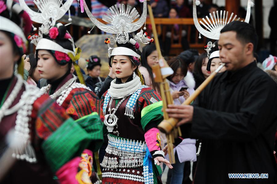 People in traditional costumes perform the lusheng dance in Zhouxi Town, Kaili City of southwest China\'s Guizhou Province, Feb. 24, 2019. The ethnic Miao girls donning traditional embroidered attire and silver ornaments sing and dance to the sound of the lusheng, a reed-pipe wind instrument, to pray for a good harvest. Ethnic Miao people get together at Gannangxiang to rejoice in the annual Gannangxiang celebration, one of the largest-scale and most primitive Miao lusheng celebrations in Guizhou Province. (Xinhua/Yang Wenbin)