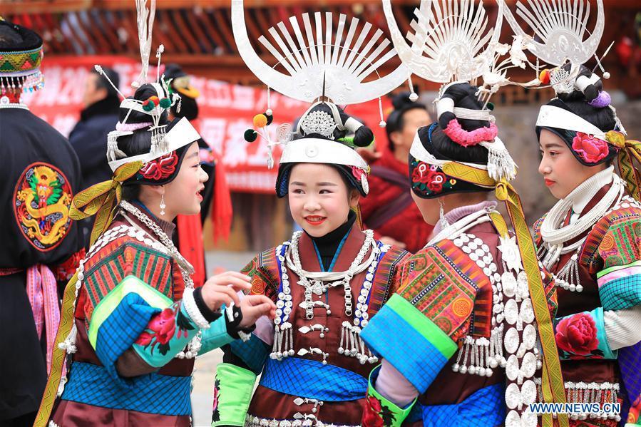 Villagers in traditional costumes are seen during the Gannangxiang celebration in Zhouxi Town, Kaili City of southwest China\'s Guizhou Province, Feb. 24, 2019. The ethnic Miao girls donning traditional embroidered attire and silver ornaments sing and dance to the sound of the lusheng, a reed-pipe wind instrument, to pray for a good harvest. Ethnic Miao people get together at Gannangxiang to rejoice in the annual Gannangxiang celebration, one of the largest-scale and most primitive Miao lusheng celebrations in Guizhou Province. (Xinhua/Wu Jibin)