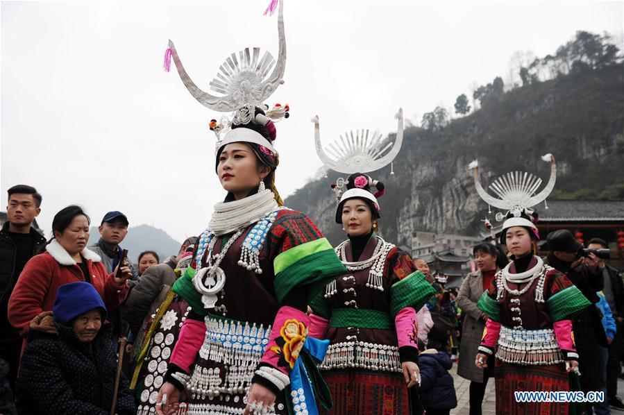 Villagers in traditional costumes perform the lusheng dance in Zhouxi Town, Kaili City of southwest China\'s Guizhou Province, Feb. 24, 2019. The ethnic Miao girls donning traditional embroidered attire and silver ornaments sing and dance to the sound of the lusheng, a reed-pipe wind instrument, to pray for a good harvest. Ethnic Miao people get together at Gannangxiang to rejoice in the annual Gannangxiang celebration, one of the largest-scale and most primitive Miao lusheng celebrations in Guizhou Province. (Xinhua/Yang Wenbin)