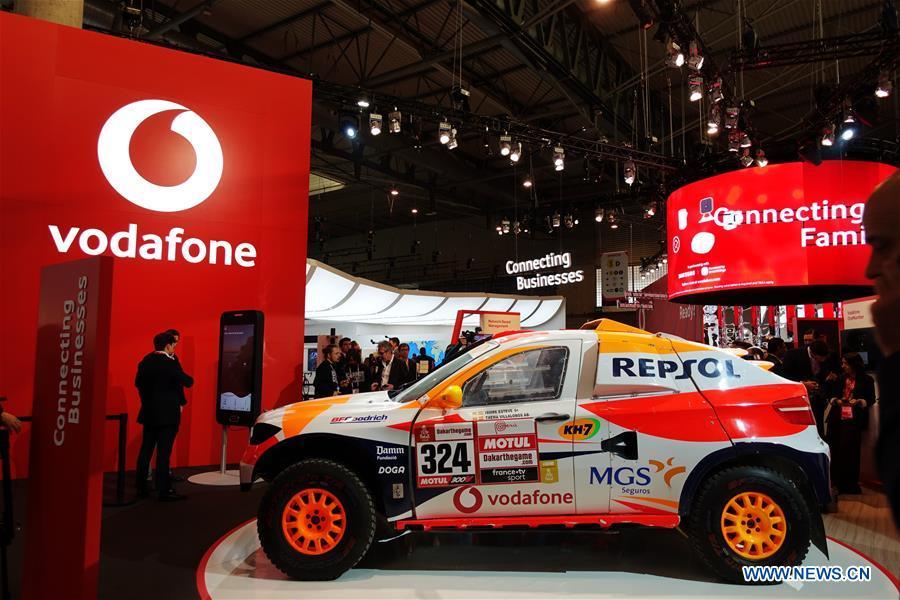 People are seen at the booth of mobile company Vodafone at the 2019 Mobile World Congress (MWC) in Barcelona, Spain, Feb. 25, 2019. The four-day 2019 MWC opened on Monday in Barcelona. (Xinhua/Guo Qiuda)