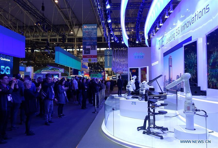 Visitors take pictures of a ZTE drum robot at the 2019 Mobile World Congress (MWC) in Barcelona, Spain, Feb. 25, 2019. The four-day 2019 MWC opened on Monday in Barcelona. (Xinhua/Guo Qiuda)
