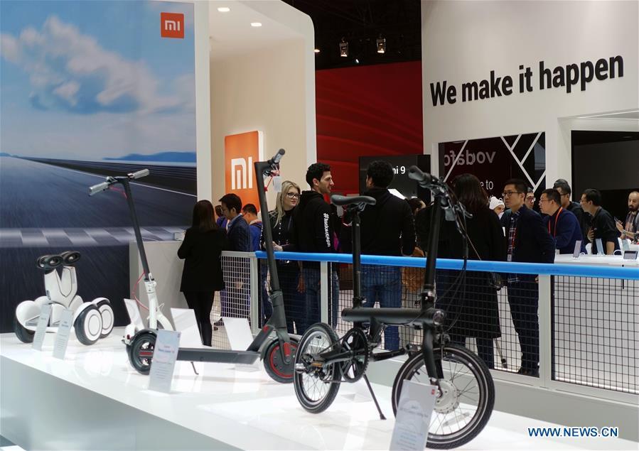 People are seen at the booth of Chinese tech company Xiaomi at the 2019 Mobile World Congress (MWC) in Barcelona, Spain, Feb. 25, 2019. The four-day 2019 MWC opened on Monday in Barcelona. (Xinhua/Guo Qiuda)
