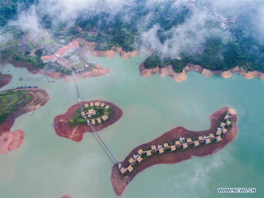 Aerial photo taken on May 31, 2018 shows Yunhe lake tourist resort in Yunhe County, Lishui City, east China\'s Zhejiang Province. China Development Bank (CDB), the world\'s largest development finance institution, has extended trillions of yuan of loans to support the development of the Yangtze River Economic Belt. As of December 2018, outstanding loans to 11 provincial-level regions along the belt amounted to 3.85 trillion yuan (about 575 billion U.S. dollars), according to the CDB. New yuan loans to these regions reached 304.5 billion yuan last year, accounting for 48 percent of the bank\'s total new yuan loans. The funds mainly went to major projects in the fields of ecological protection and restoration, infrastructure connectivity, and industrial transformation and upgrading. The CDB will continue to support ecological protection and green development of the Yangtze River in 2019, said CDB Chairman Zhao Huan. China issued a development plan for the Yangtze River Economic Belt in September 2016 and a guideline for green development of the belt in 2017. The Yangtze River Economic Belt consists of nine provinces and two municipalities that cover roughly one-fifth of China\'s land. It has a population of 600 million and generates more than 40 percent of the country\'s GDP. (Xinhua/Xu Yu)