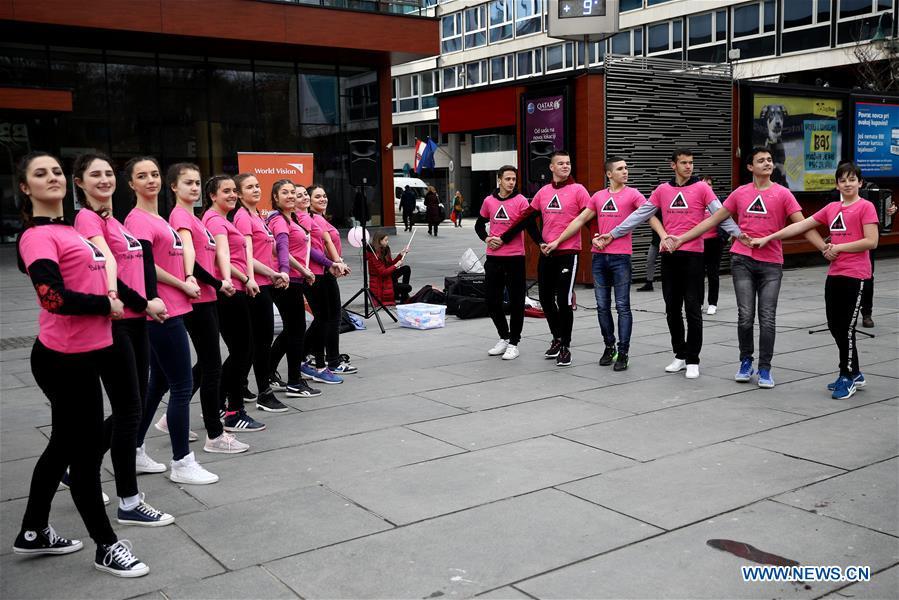 Dancers dressed in pink shirts perform a traditional dance during the Pink Shirt Day event calling for the prevention of peer violence, in Sarajevo, Bosnia and Herzegovina (BiH), on Feb. 27, 2019. The event held in the city center of Sarajevo on Wednesday attracted several hundred residents, who were informed about how to recognize the peer violence, and how to prevent it through conversation and quality time spending with a child who suffered some form of violence. (Xinhua/Nedim Grabovica)