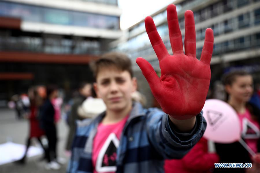 A boy shows his hand covered with red color that represents attitude towards peer violence during the Pink Shirt Day event calling for the prevention of peer violence, in Sarajevo, Bosnia and Herzegovina (BiH), on Feb. 27, 2019. The event held in the city center of Sarajevo on Wednesday attracted several hundred residents, who were informed about how to recognize the peer violence, and how to prevent it through conversation and quality time spending with a child who suffered some form of violence. (Xinhua/Nedim Grabovica)