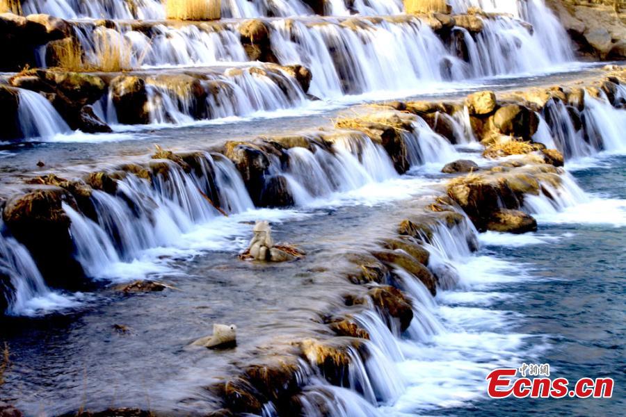 Melting snow in the Qilian Mountains caused water levels to rise in a river, forming a beautiful series of natural waterfalls in Zhangye City, Gansu Province as temperatures rose in late February. (Photo: China News Service/Chen Li)