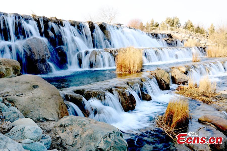Melting snow in the Qilian Mountains caused water levels to rise in a river, forming a beautiful series of natural waterfalls in Zhangye City, Gansu Province as temperatures rose in late February. (Photo: China News Service/Chen Li)