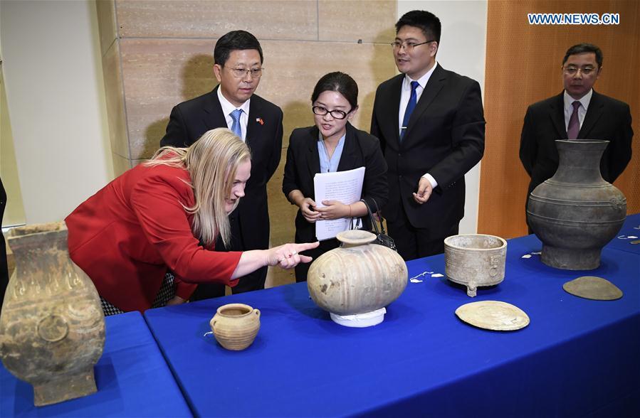 Deputy Administrator of China\'s National Cultural Heritage Administration Hu Bing (2nd L), Minister of the Chinese Embassy to the United States Li Kexin (1st R), Deputy Assistant Secretary for Policy, U.S. Department of State\'s Bureau of Educational and Cultural Affairs, Aleisha Woodward (1st L) view relics on display during a repatriation event held in the Eiteljorg Museum of Indianapolis, capital of state of Indiana, the United States, on Feb. 2, 2019. The United States announced the repatriation of 361 pieces of Chinese relics and artifacts to China at a ceremony on Thursday. (Xinhua/Liu Jie)