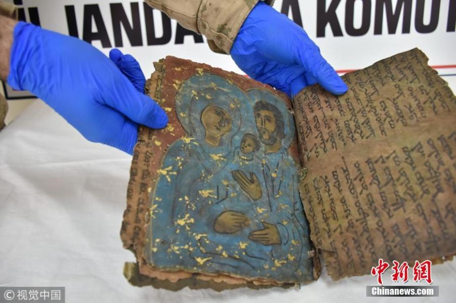 An 800-year-old Hebrew book seized in an anti-smuggling operation is on display in Diyarbakir, Turkey, Feb. 28, 2019. Police detained four suspects trying to illegally sell the book. Filled with Hebrew scripts, the leather book of some 22 pages is believed to contain religious texts. (Photo/VCG)