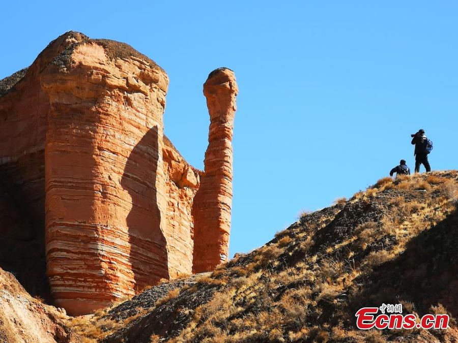 The Binggou Danxia landform in Sunan Yugur Autonomous County, Northwest China\'s Gansu Province. The Danxia landform is a unique type of geomorphology formed from red-colored sandstone and characterized by steep cliffs. The Danxia landform in the Binggou (glacial gully) scenic area is particularly known for its magnificence and strange shapes. (Photo: China News Service/Wu Xuezhen)