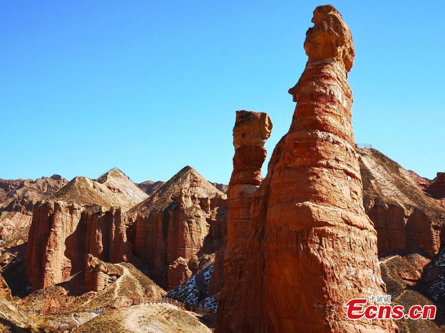 The Binggou Danxia landform in Sunan Yugur Autonomous County, Northwest China\'s Gansu Province. The Danxia landform is a unique type of geomorphology formed from red-colored sandstone and characterized by steep cliffs. The Danxia landform in the Binggou (glacial gully) scenic area is particularly known for its magnificence and strange shapes. (Photo: China News Service/Wu Xuezhen)