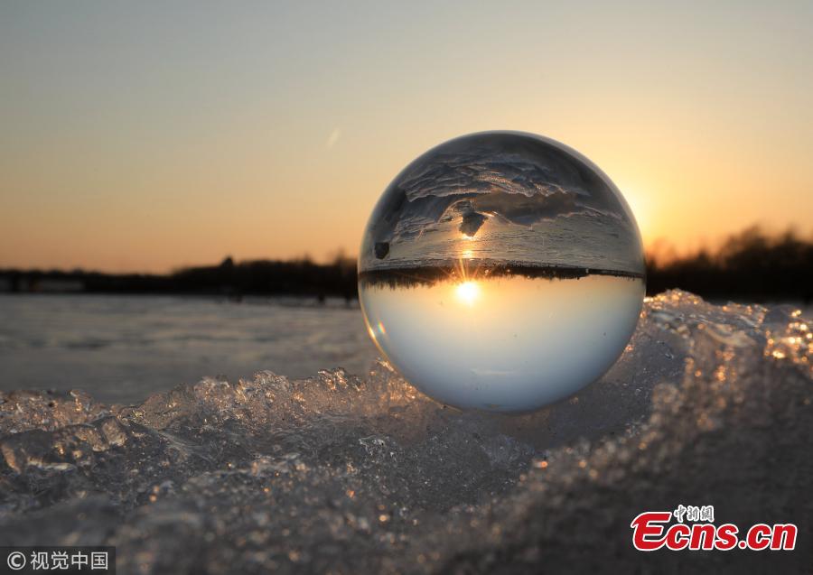 Refraction photography using a crystal ball on ice shows a view of the landscape near the Songhua River in Harbin City, Heilongjiang Province, March 4, 2019. (Photo/VCG)