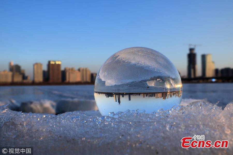 Refraction photography using a crystal ball on ice shows a view of the landscape near the Songhua River in Harbin City, Heilongjiang Province, March 4, 2019. (Photo/VCG)
