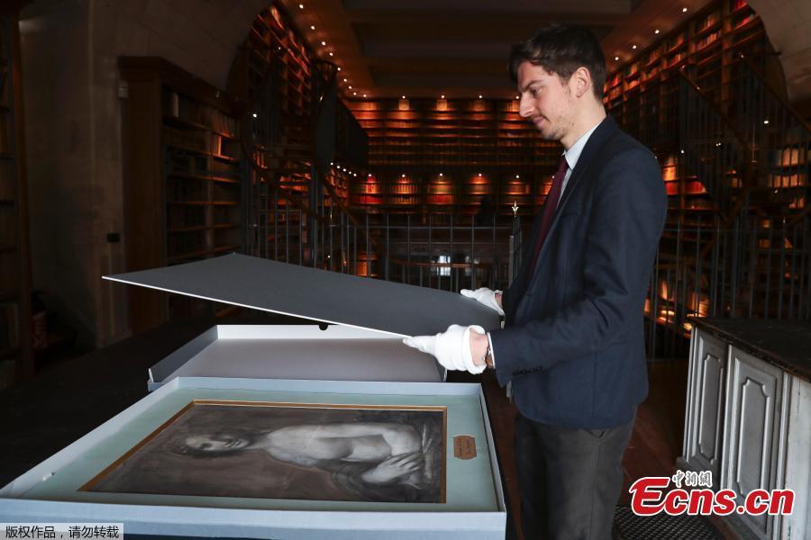 Curator at the Conde Museum Mathieu Deldicque handles a charcoal drawing known as the \