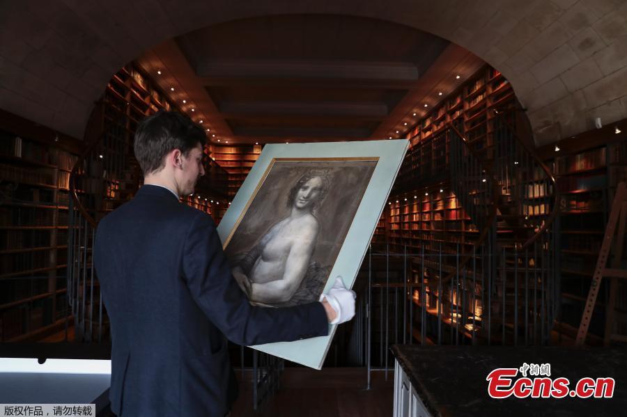 Curator at the Conde Museum Mathieu Deldicque holds a charcoal drawing known as the \