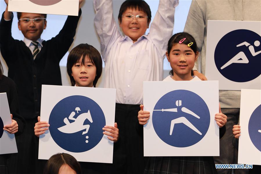 Children display sport pictograms for the Tokyo 2020 Summer Olympic Games at the unveiling event in Tokyo, Japan, on March 12, 2019. (Xinhua/Du Xiaoyi)