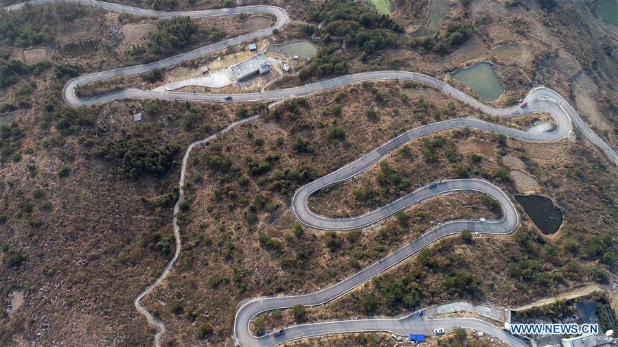 Aerial Photo taken on March 11, 2019 shows the winding concrete road from Kaili City to Dangguo Village in southwest China\'s Guizhou Province. The concrete road project in Guizhou was launched in August, 2017. Up to now, Guizhou has seen 77,700 kilometers of rural roads built or renovated with nearly 40,000 villages connected by concrete roads. Tens of millions of rural people benefit from the project. (Xinhua/Wu Jibin)