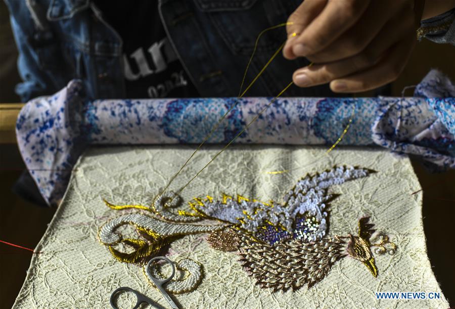 Renagul embroiders for haute couture at her workshop in Yizhou District of Hami City, northwest China\'s Xinjiang Uygur Autonomous Region, on March 8, 2019. The haute couture, literally named \