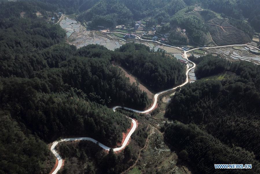 Aerial Photo taken on March 11, 2019 shows the winding concrete road at Chalu Village of Tonggu Township in Jinping County, Miao and Dong Autonomous Prefecture of Qiandongnan, southwest China\'s Guizhou Province. The concrete road project in Guizhou was launched in August, 2017. Up to now, Guizhou has seen 77,700 kilometers of rural roads built or renovated with nearly 40,000 villages connected by concrete roads. Tens of millions of rural people benefit from the project. (Xinhua/Peng Zeliang)