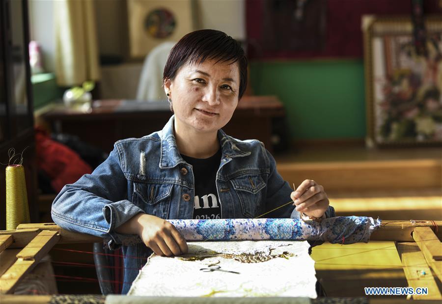 Renagul embroiders for haute couture at her workshop in Yizhou District of Hami City, northwest China\'s Xinjiang Uygur Autonomous Region, on March 8, 2019. The haute couture, literally named \