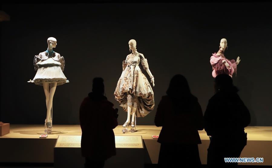 People watch creations of Chinese couturier Guo Pei at her \
