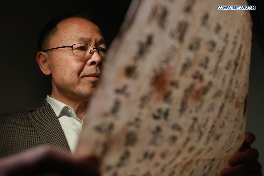 Wang Zongxun, curator of a museum of Jinping Writs, reads a document at the museum in Jinping County, southwest China\'s Guizhou Province, March 18, 2019. Dating back to the Ming Dynasty (1368-1644), \