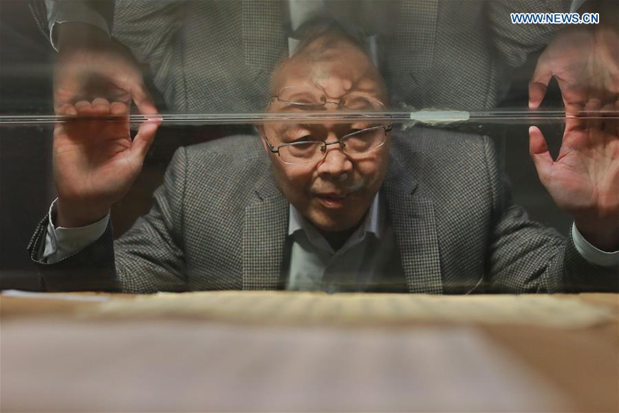 Wang Zongxun, curator of a museum of Jinping Writs, checks the document on display at the museum in Jinping County, southwest China\'s Guizhou Province, March 18, 2019. Dating back to the Ming Dynasty (1368-1644), \