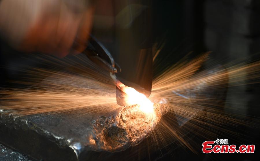 Craftsman Ding Jican makes Zhang Xiaoquan scissors using traditional methods in Hangzhou City, East China\'s Zhejiang Province, March 18, 2019. Zhang Xiaoquan scissors are a famous brand with a long history in China, and Ding has been committed to making the household utensil for 40 years. Ding himself is a master of the Zhang Xiaoquan scissor-making techniques, which have been perfected over the centuries and are recognized in China as a state intangible cultural heritage. (Photo: China News Service/Wang Gang)