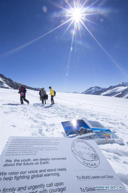 Copies of a postcard calling for action against climate change are seen on the Aletsch glacier under Jungfraujoch in Switzerland, on March 20, 2019. Some 900 postcards from youths all over the world were stamped and sent on Wednesday from Europe\'s highest postbox on the Jungfraujoch peak, Switzerland, to global leaders, calling for action against climate change. (Xinhua/Xu Jinquan)