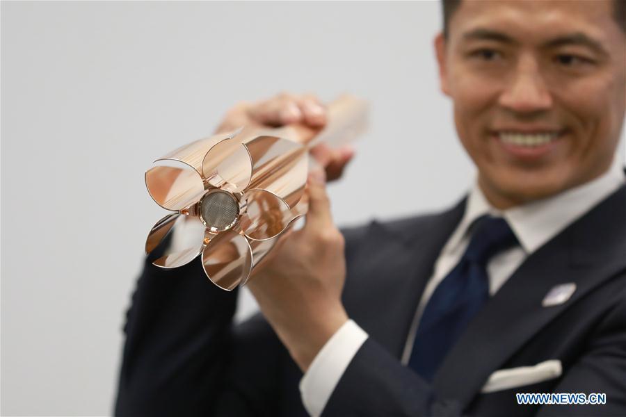 Tokyo 2020 Torch Relay Ambassador, Japanese athlete Tadahiro Nomura shows the design of the Tokyo 2020 Olympic Torch in Tokyo, Japan, on March 20, 2019. The Tokyo Organising Committee of the Olympic and Paralympic Games (Tokyo 2020) unveiled the prototype of the Tokyo 2020 Olympic Torch on Wednesday. The motif of Tokyo 2020 Olympic Torch is cherry blossom. Aluminum recycled from temporary housing used in areas struck by the Great East Japan Earthquake disaster will be used to manufacture the torch. (Xinhua/Du Xiaoyi)