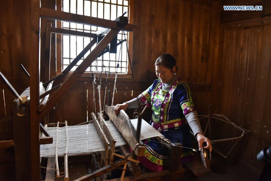 A woman of Dong ethnic group weaves cloth at Laozhai Village of Yuping Dong Autonomous county of Tongren, southwest China\'s Guizhou Province, March 23, 2019. Traditional Dong cloth making has a long history. The procedure includes planting cotton, spinning, weaving, dyeing, etc. And the cloth enjoys lasting popularity among the people of Dong ethnic group. (Xinhua/Long Mengqian)