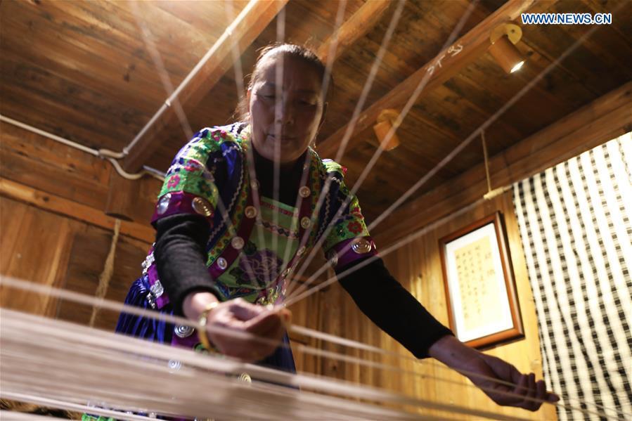 A woman of Dong ethnic group weaves cloth at Laozhai Village of Yuping Dong Autonomous county of Tongren, southwest China\'s Guizhou Province, March 23, 2019. Traditional Dong cloth making has a long history. The procedure includes planting cotton, spinning, weaving, dyeing, etc. And the cloth enjoys lasting popularity among the people of Dong ethnic group. (Xinhua/Wang Changyu)