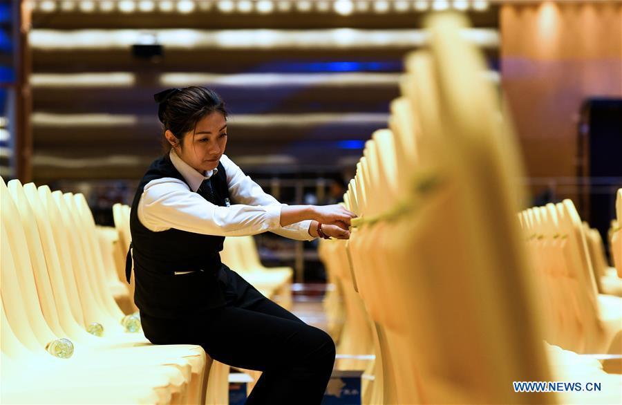 A staff member checks chairs in the main venue of the Boao Forum for Asia (BFA) in Boao Town of Qionghai City, south China\'s Hainan Province, March 24, 2019. The BFA annual conference will be held in Boao from March 26 to 29 under the theme of \