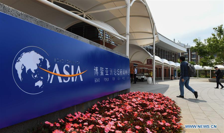 A journalist walks into the media center in Boao Town of Qionghai City, south China\'s Hainan Province, March 25, 2019. The BFA annual conference will be held in Boao from March 26 to 29 under the theme of \