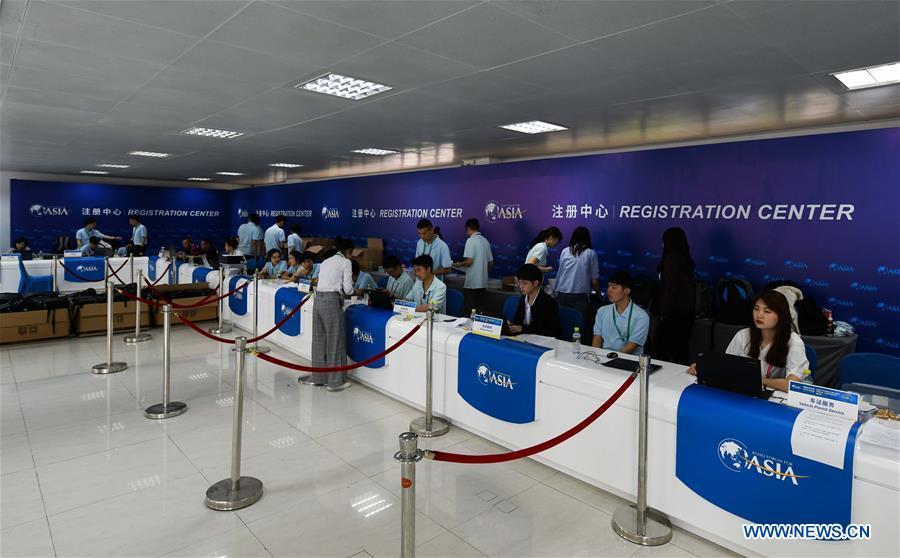 Staff members work at the registration center of the Boao Forum for Asia (BFA) in Boao Town of Qionghai City, south China\'s Hainan Province, March 25, 2019. The BFA annual conference will be held in Boao from March 26 to 29 under the theme of \